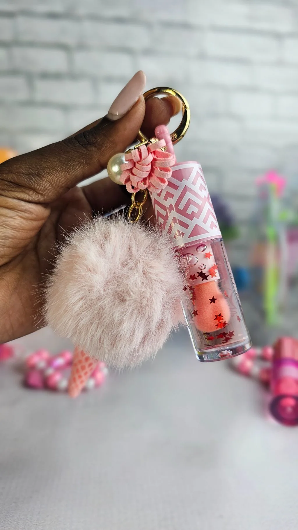 Pink pom pom colour changing lipgloss
