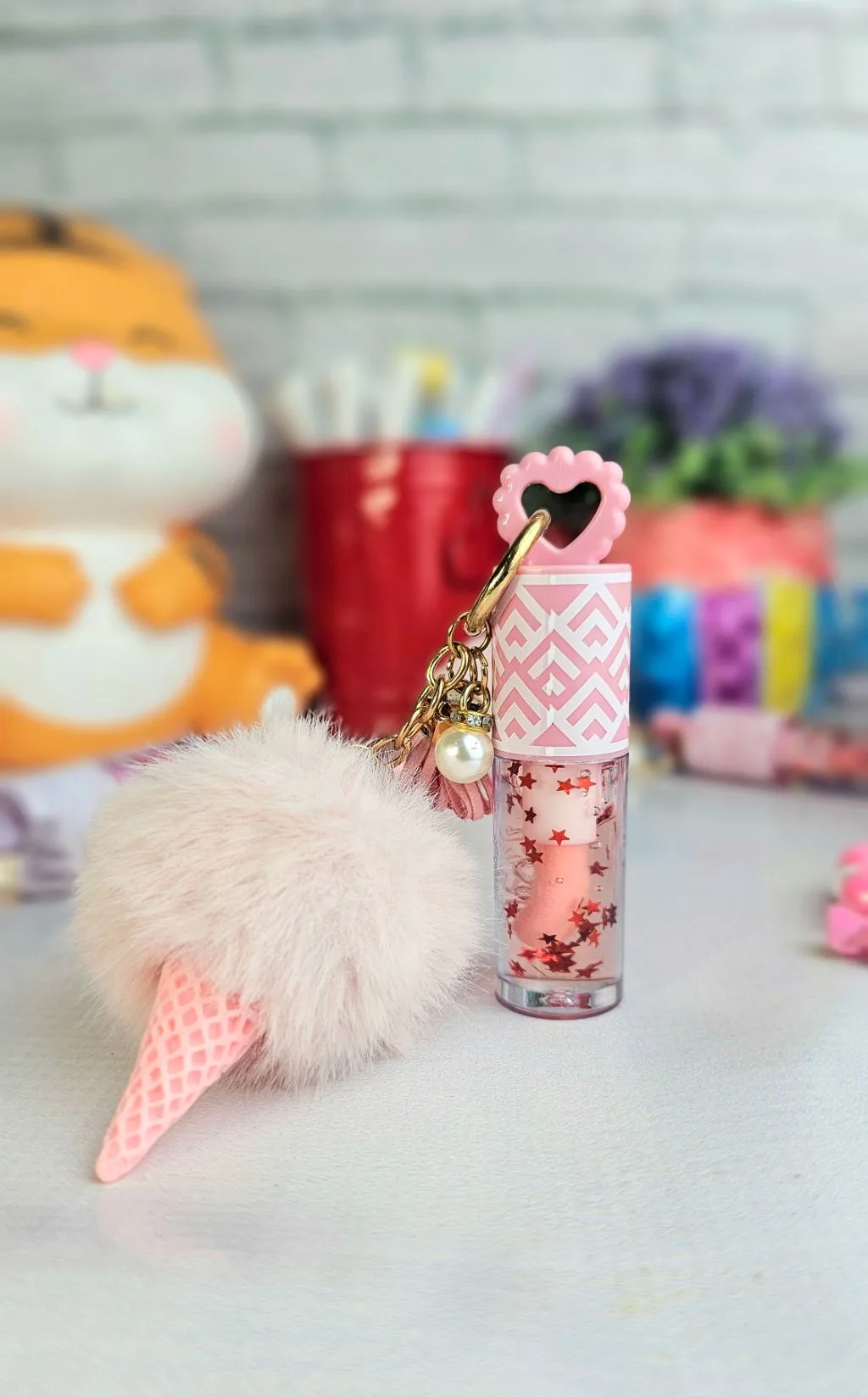 Pink pom pom colour changing lipgloss