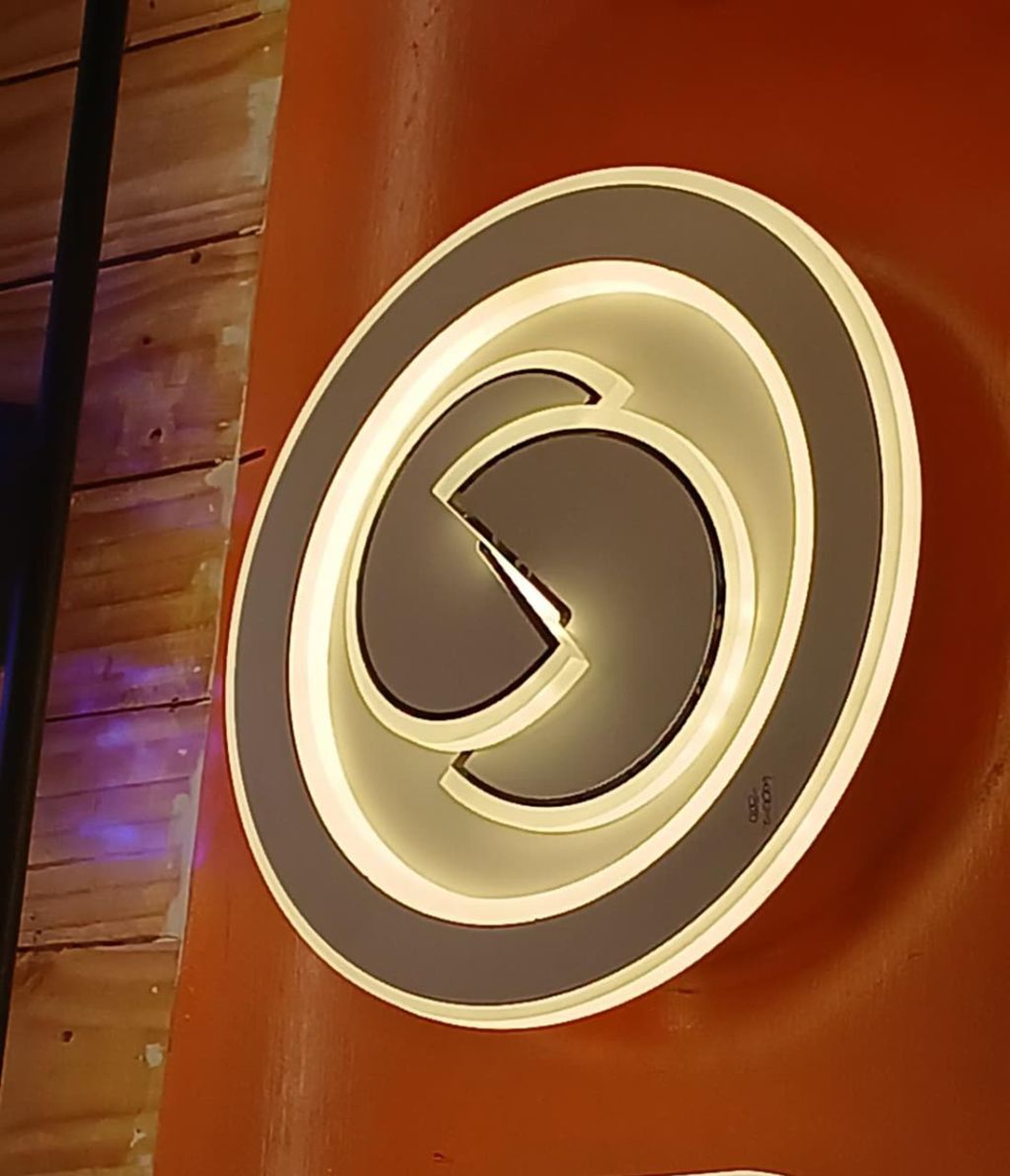 Modern Circular LED Wall Light with Interlocking Spiral Silhouette