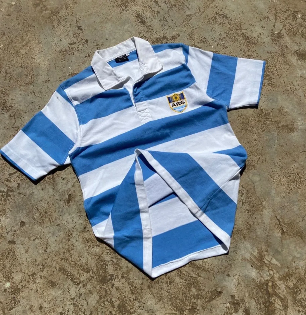 Argentina rugby polo with blue and white horizontal stripes.