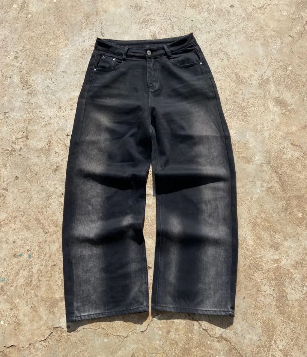 Faded black wide-leg baggy jeans with sun-fade wash.