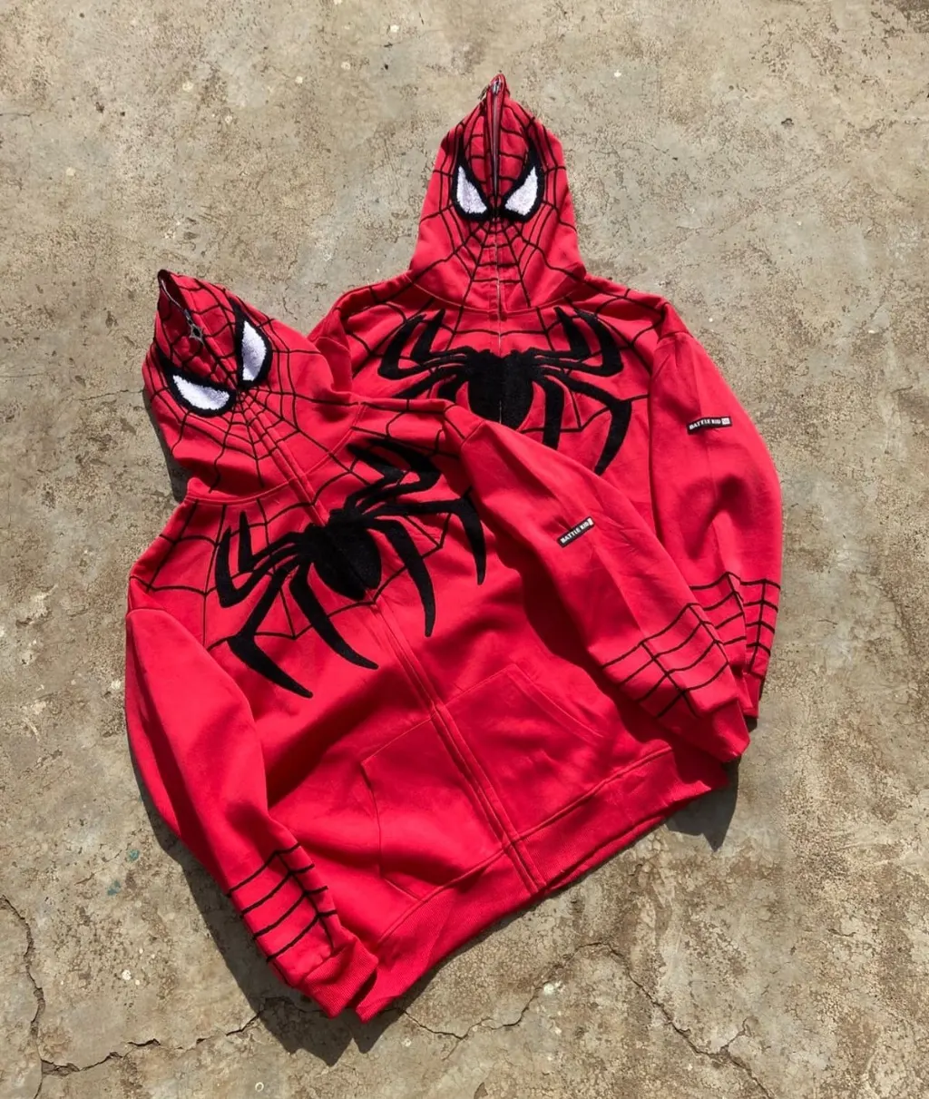 Red full-zip hoodie with Spider-Man web print and 3D hood eyes.