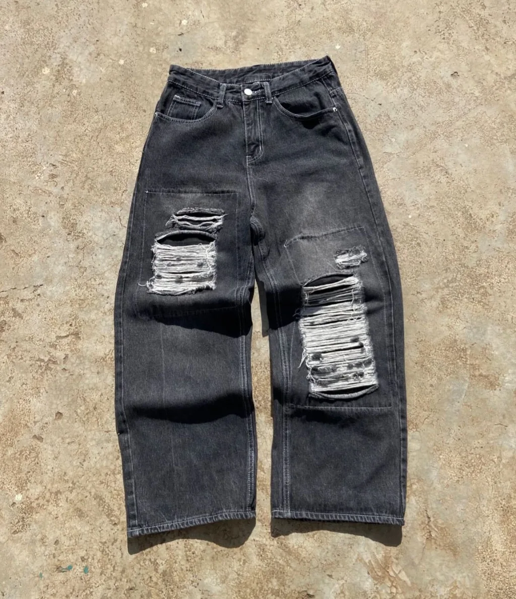 Washed black wide-leg baggy jeans with heavy distressed rips.