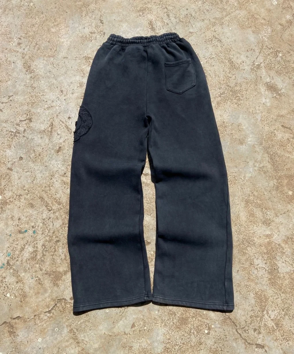 Black faded wide-leg sweatpants with tonal embroidered patches.