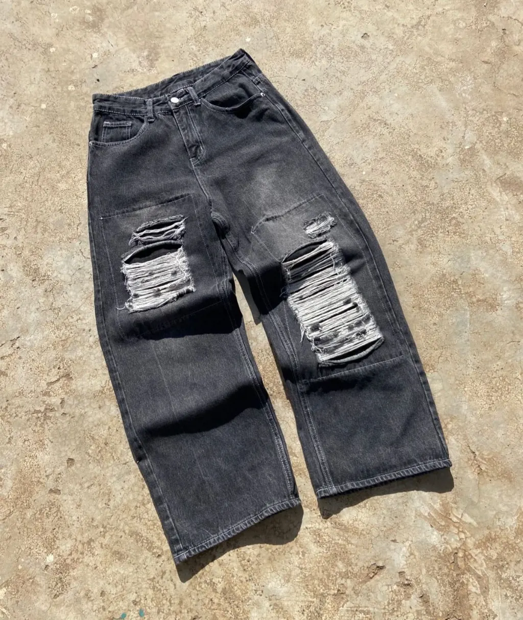 Washed black wide-leg baggy jeans with heavy distressed rips.