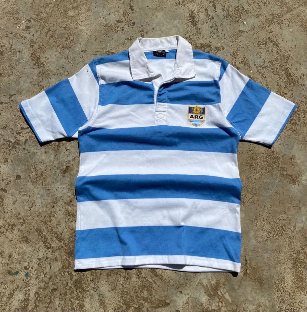 Argentina rugby polo with blue and white horizontal stripes.