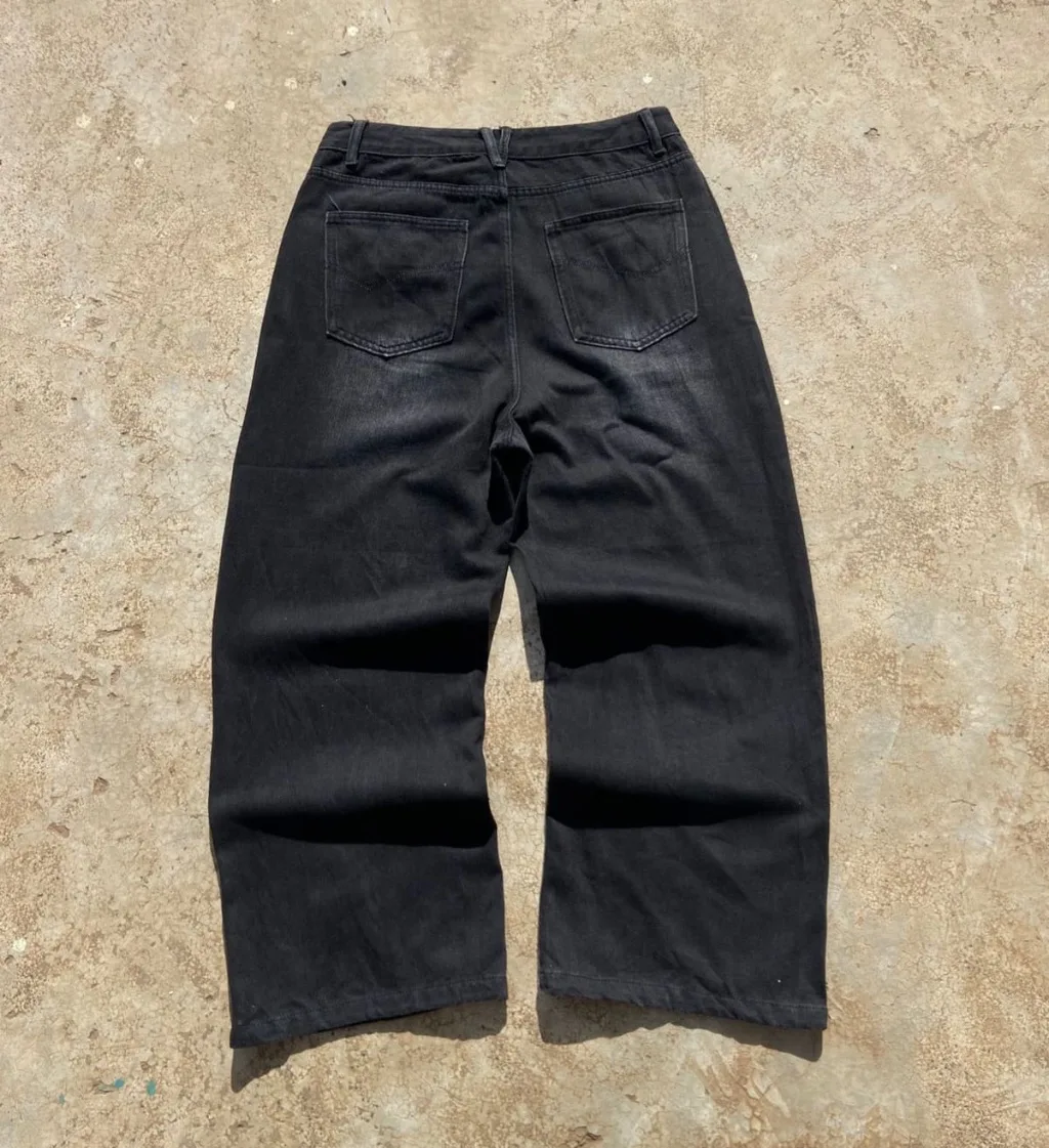 Washed black wide-leg baggy jeans with heavy distressed rips.