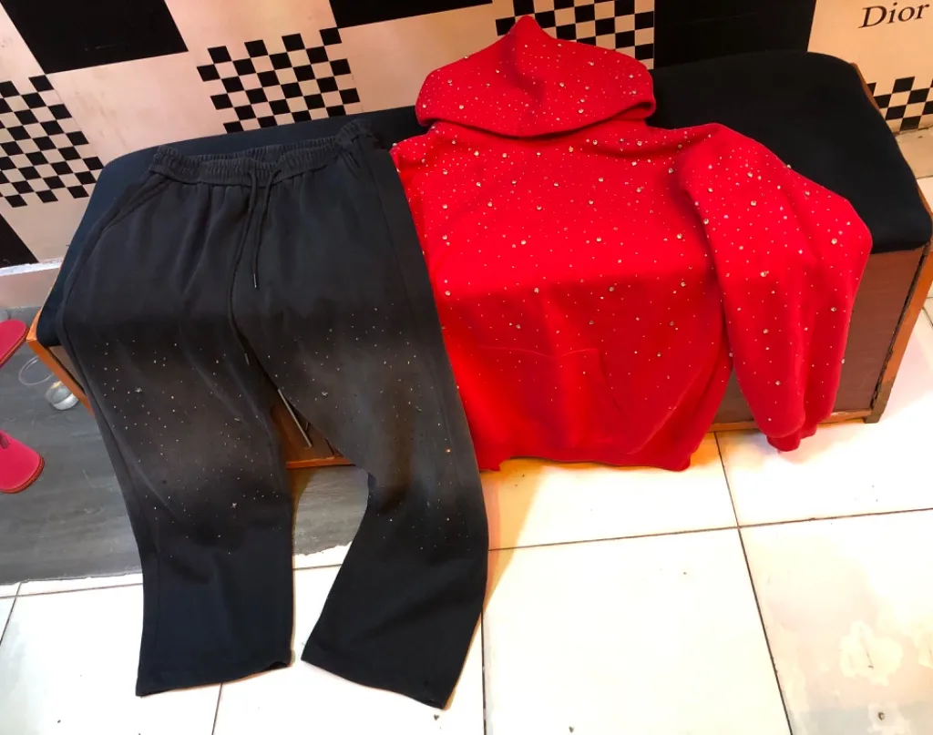 Red rhinestone hoodie + black flared sweatpants set.