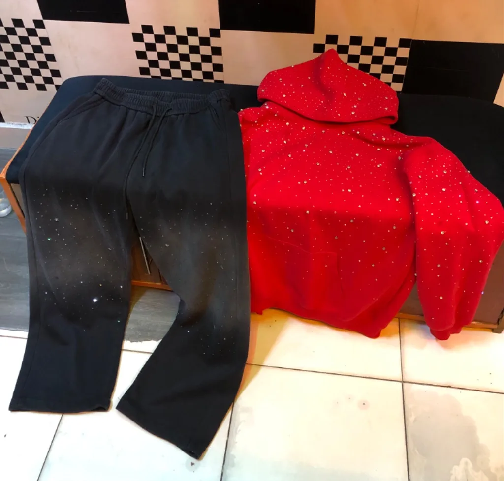 Red rhinestone hoodie + black flared sweatpants set.