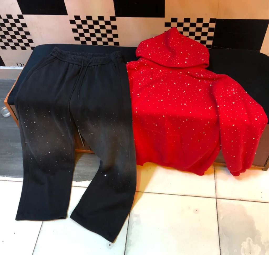 Red rhinestone hoodie + black flared sweatpants set.