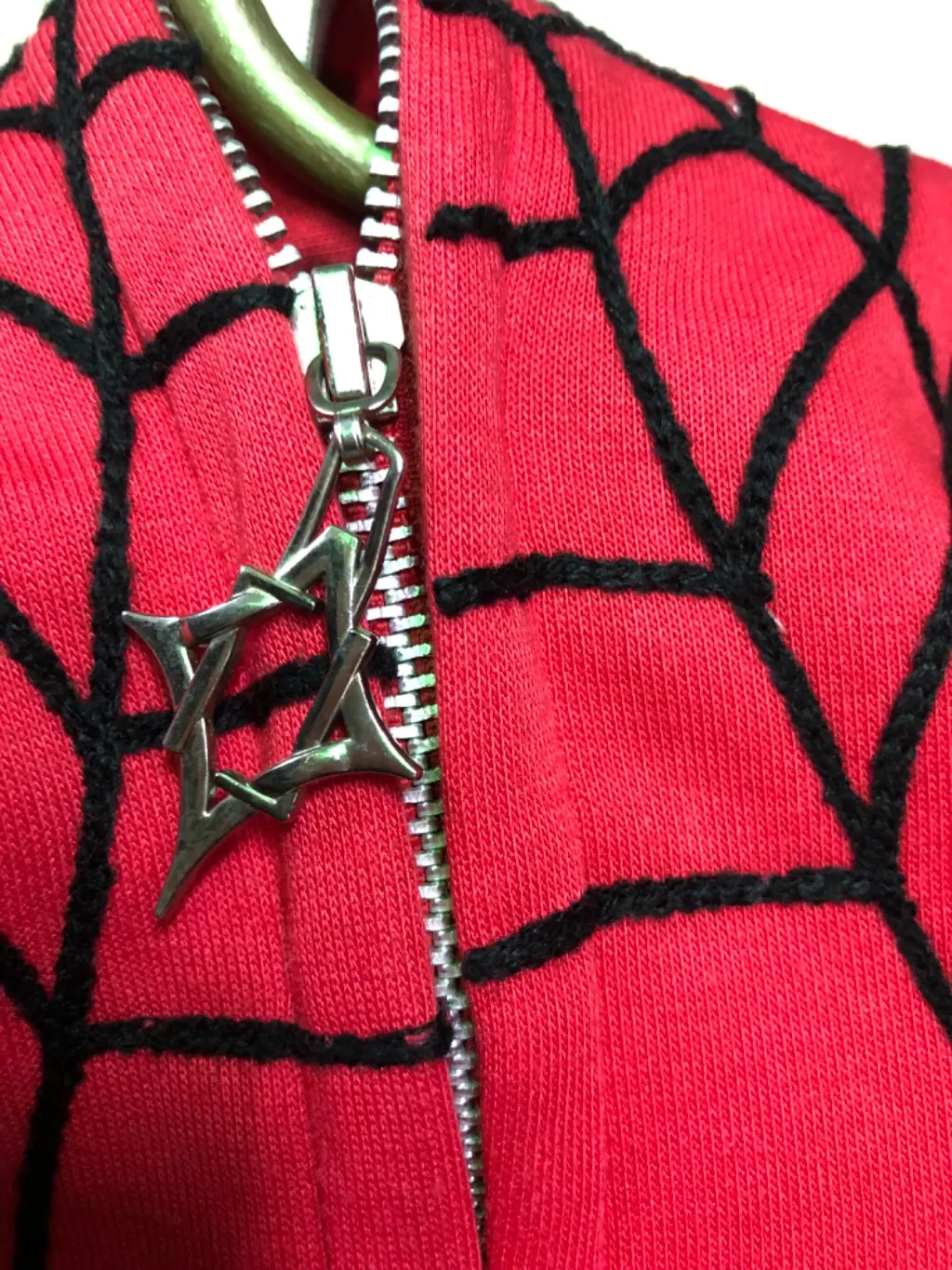 Red full-zip hoodie with Spider-Man web print and 3D hood eyes.