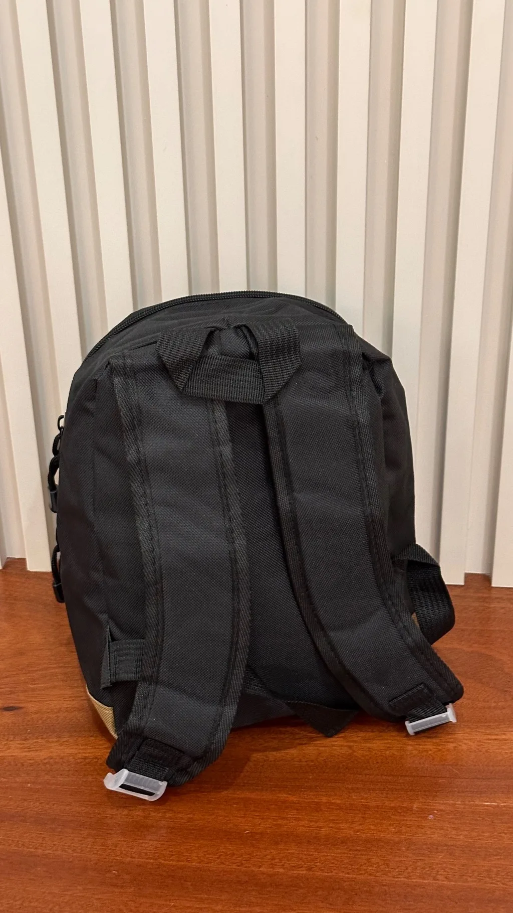 This black and tan canvas casual mini backpack