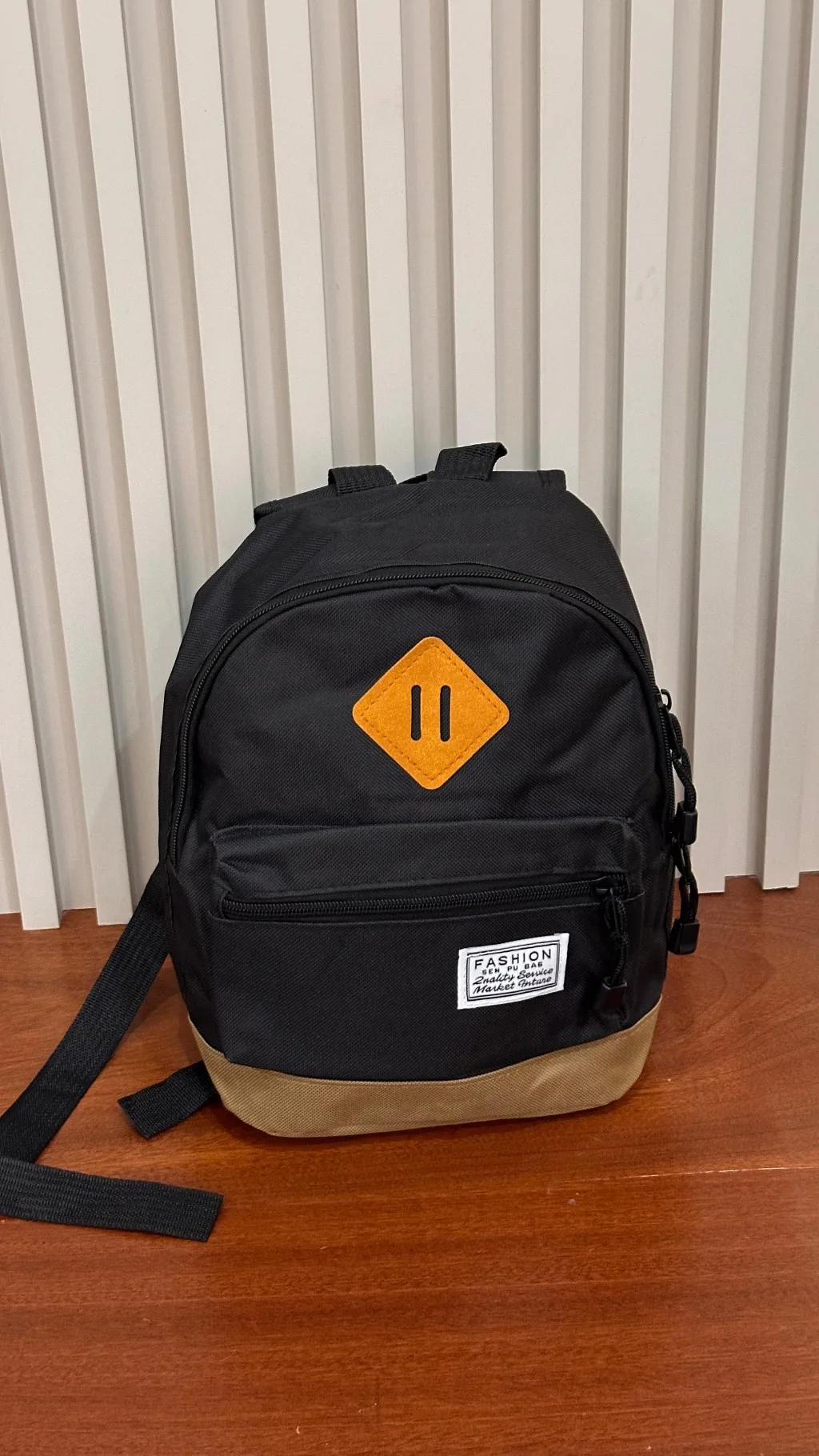 This black and tan canvas casual mini backpack